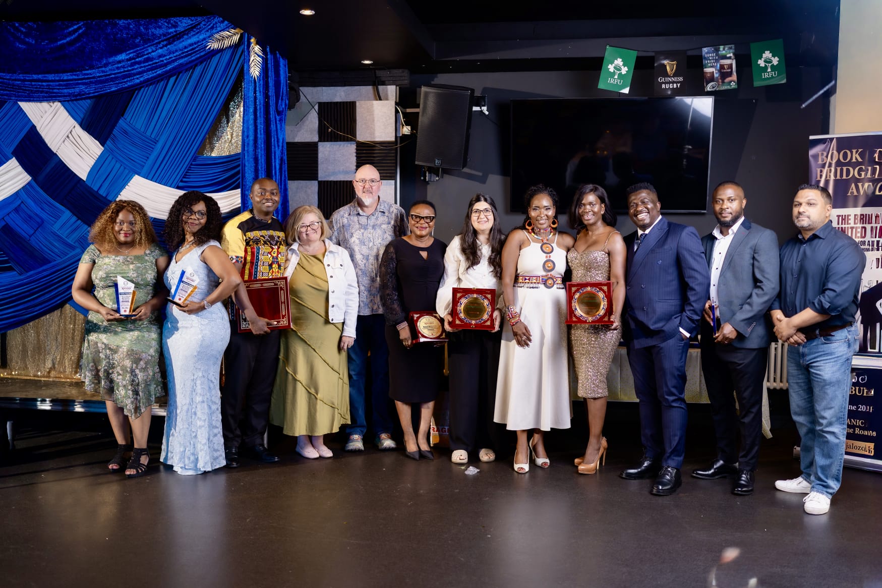 Honourees on stage with their awards at the close of the ceremony